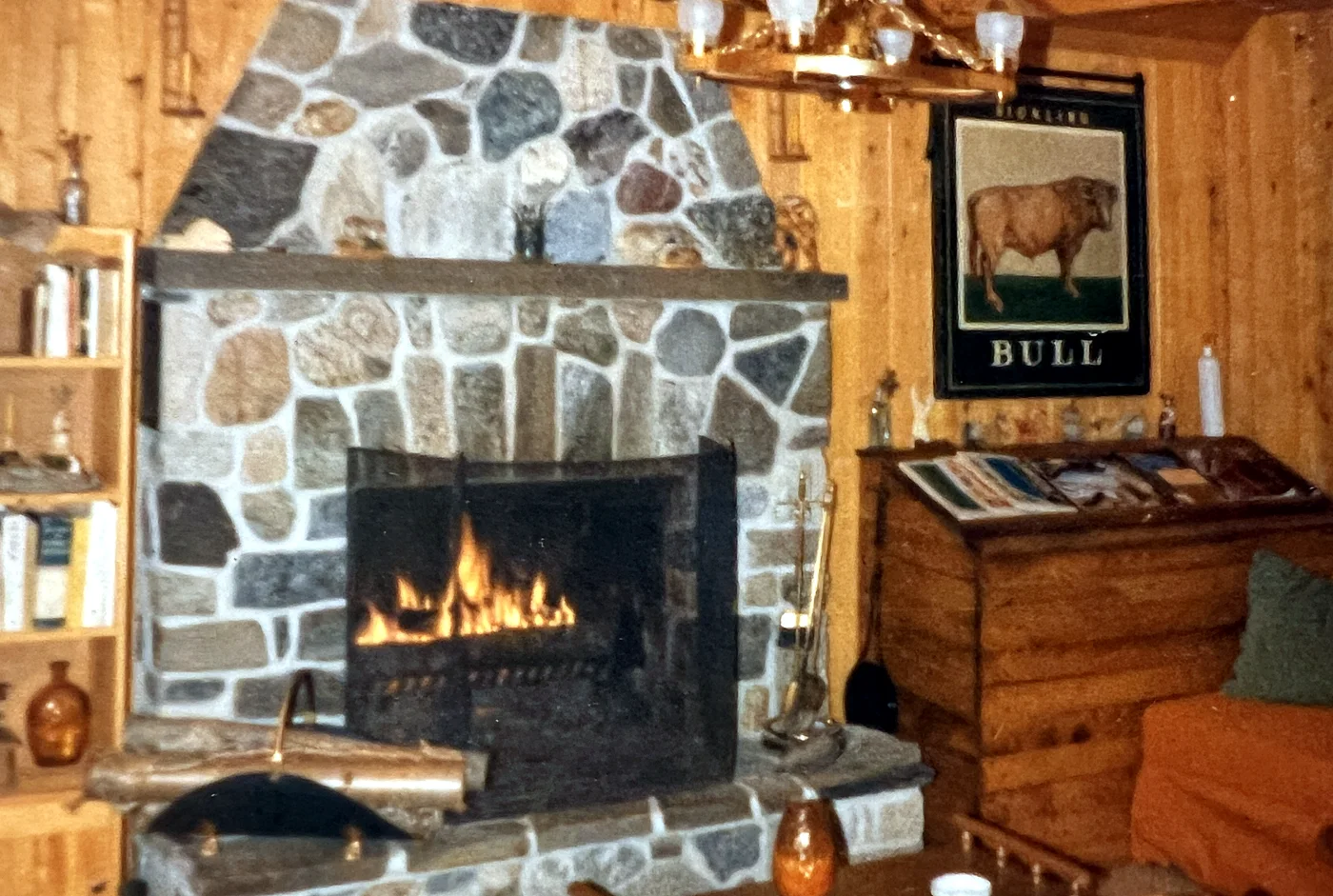 The fireplace with the old wood box on the right — and up on the wall, the Hickling Bull sign. It hung outside a pub in England until a frie…